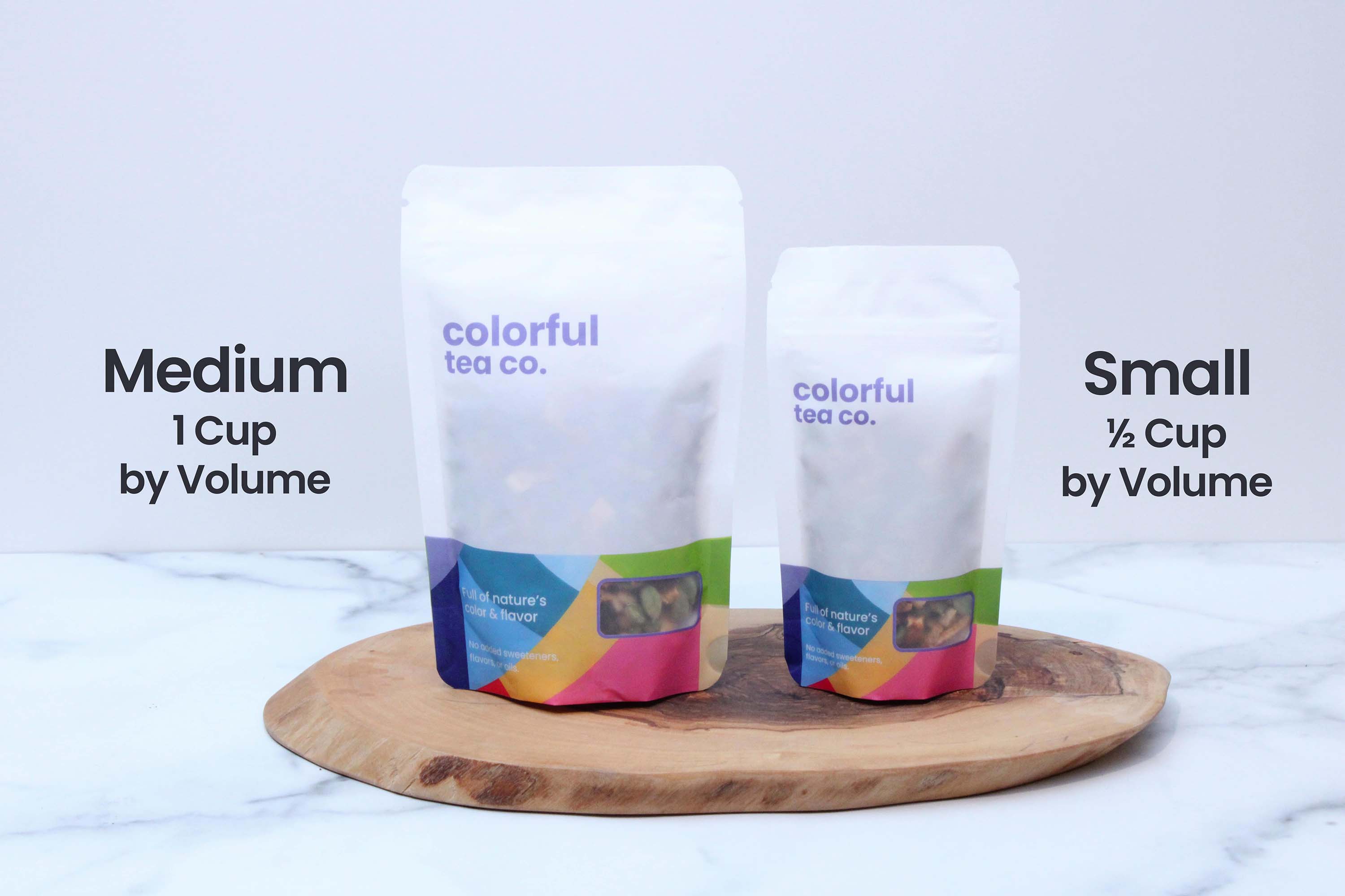 two bags of coffee sitting on top of a wooden tray