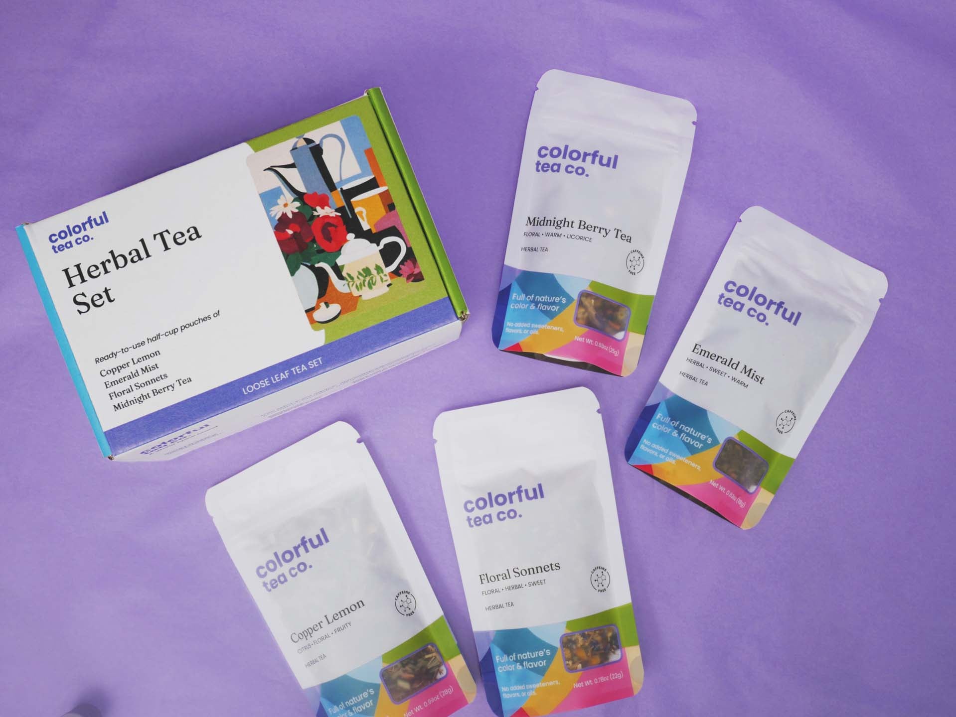 three packets of colorful tea on a purple background