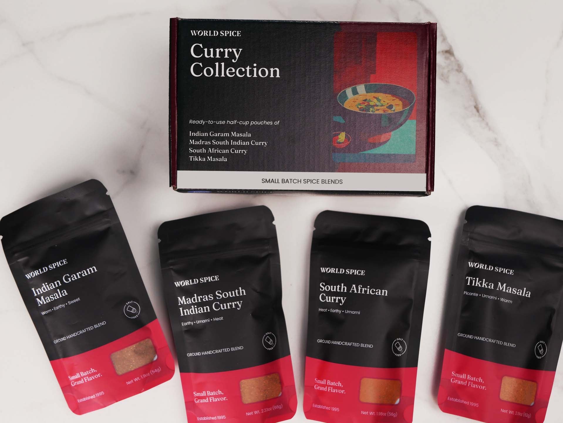 four packets of curry on a marble counter top