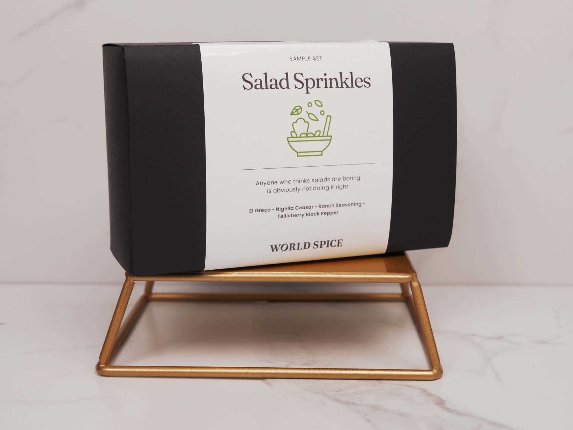 a box of salad sprinkles sitting on a stand